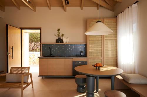 a kitchen with a table and a dining room at Epiphany Villas Lefkada in Tsoukaladhes