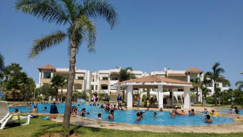 a group of people in a swimming pool at a resort at Asilah marina golf in Asilah