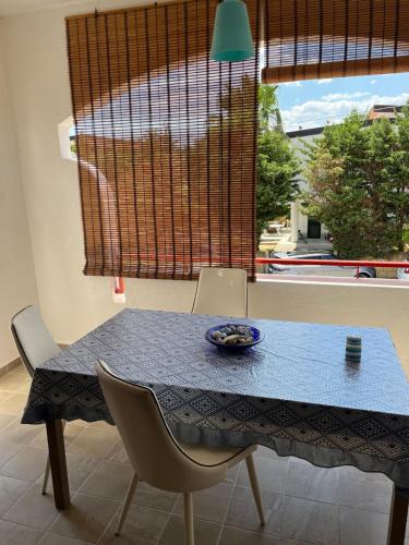 a blue table with two chairs and a bowl on it at Marianna's Holidays in Montepaone