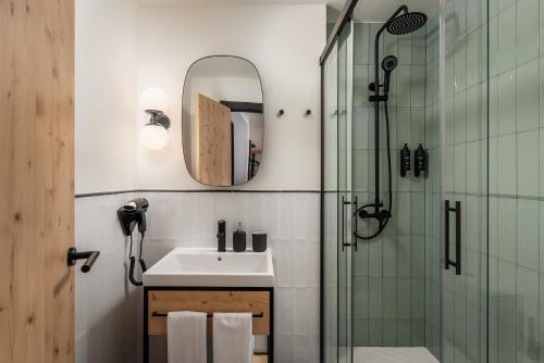 a bathroom with a sink and a shower at BYPILLOW Irala in Bilbao