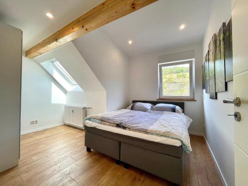 a bedroom with a bed and a window at Sky Apartment, Sauna, Blick zur Mosel, großer Balkon, Kaffeemaschine, Smart TV in Zell an der Mosel