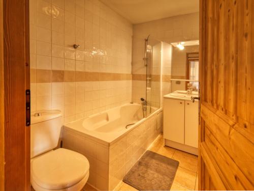 a bathroom with a tub and a toilet and a sink at Spacieux Appartement 4 Chambres Pieds des Pistes à Morillon 1100 - FR-1-642-4 in Morillon