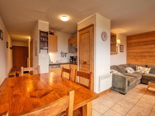 a kitchen and a living room with a wooden table at Appartement Morillon 1100, 3 pièces, 7 personnes - FR-1-642-44 in Morillon