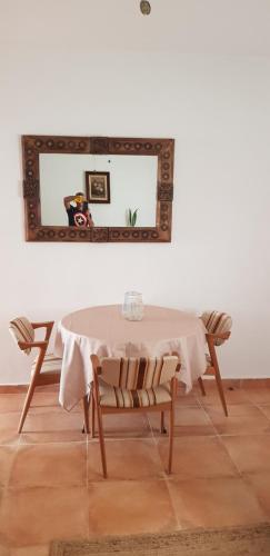 a dining room table with a mirror on the wall at Casa Rochafrida in Ossa de Montiel