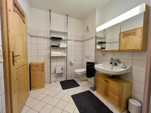 a bathroom with a sink and a toilet at Ferienwohnung AlmLust in Hochrindl