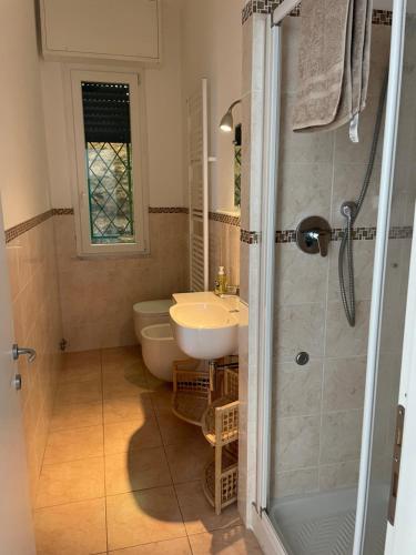 a bathroom with a sink and a toilet and a shower at Ocean View Flat with WI-FI, AC and Elevator to Town in Levanto