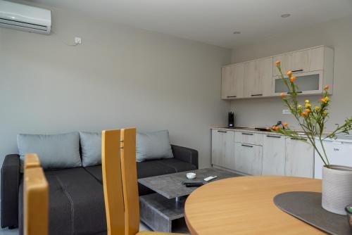 a living room with a couch and a table at Royal apartments in Bajina Bašta