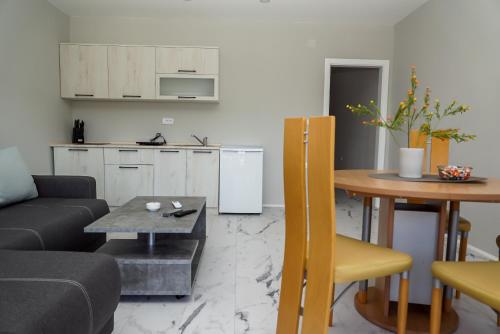 a living room with a couch and a table at Royal apartments in Bajina Bašta