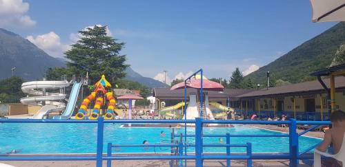 a pool with a water park with people in it at Bungalow at Lake Lugano in Porlezza