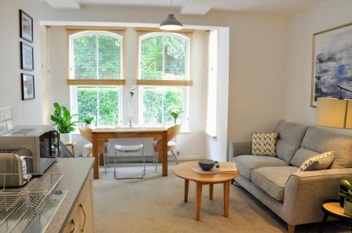 a living room with a couch and a table at Crescent House Apartments in Telford