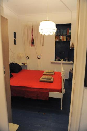 a bedroom with a red bed with towels on it at Dandy Villas Velanidia Sailor's House - Private Maisonette - Sea View in Velanídhia