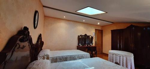 a bedroom with a bed and a table and chairs at AZTIETA CASA RURAL in Leitza
