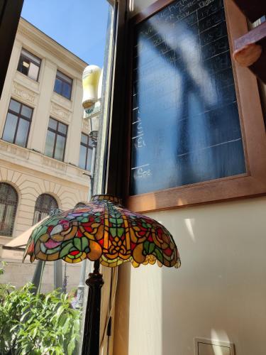 a stained glass umbrella in front of a window at Rembrandt Old Town in Bucharest