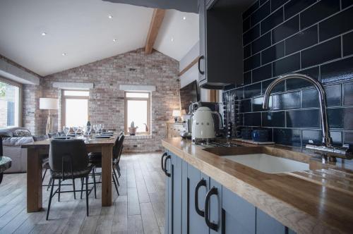 a kitchen with a counter and a dining room at Bayview House - 4 Bedroom Luxurious Holiday Home - Saundersfoot in Saundersfoot