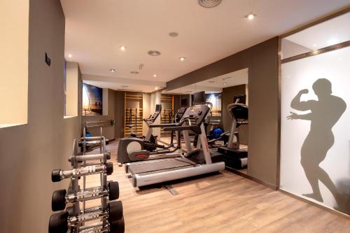 a gym with treadmills and cardio machines at Catalonia Excelsior in Valencia
