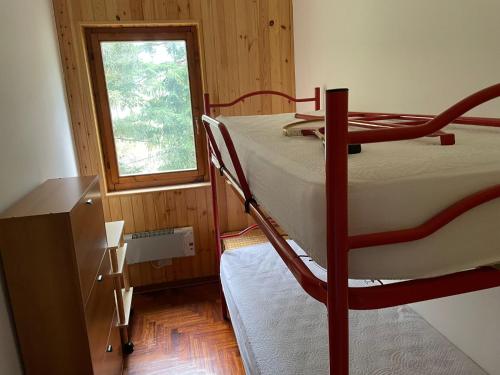 a bedroom with two bunk beds and a window at NadSan Mountain House in Camigliatello Silano