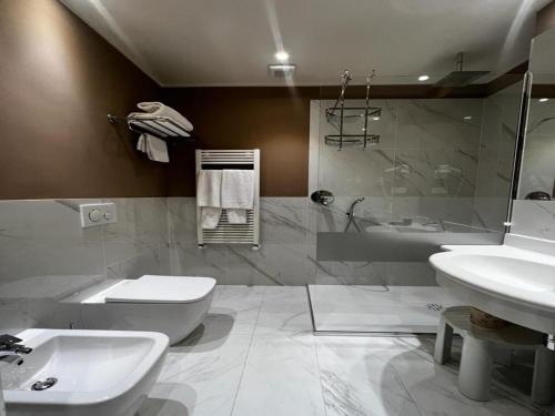 a bathroom with a sink and a toilet and a shower at Savoia Hotel Country House Bologna in Bologna