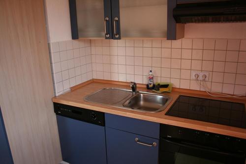 a kitchen with a sink and a counter top at Sunshine Apartment 5 in Nidda
