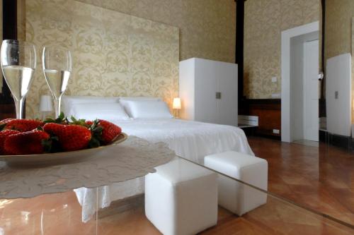 a bedroom with a bed and a bowl of strawberries on a table at Maiori Dream Rental in Maiori