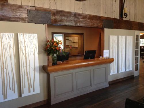 an office with a reception counter with a mirror at The Inn at Pasatiempo in Santa Cruz