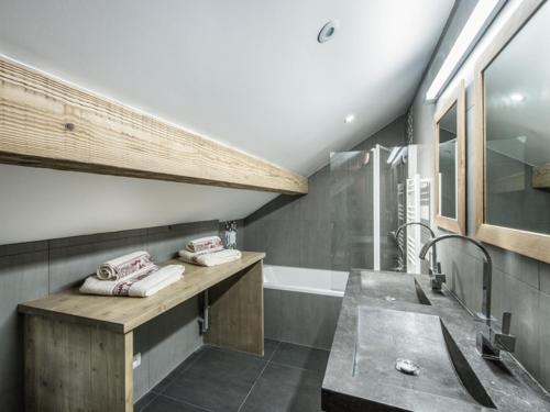 a bathroom with a sink and a bath tub at Superbe duplex central à Méribel pour 8 pers, proche pistes - FR-1-565-16 in Les Allues