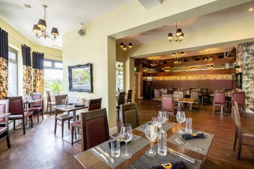 a dining room with tables and chairs and a restaurant at THE INN Hotel Bar and Restaurant in Saint Helier Jersey