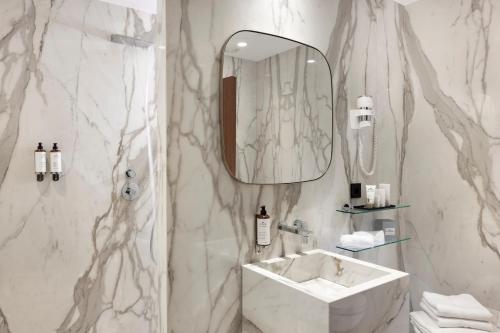 a white bathroom with a sink and a mirror at Howard sur Seine - Asnieres Paris La Defense in Asnières-sur-Seine