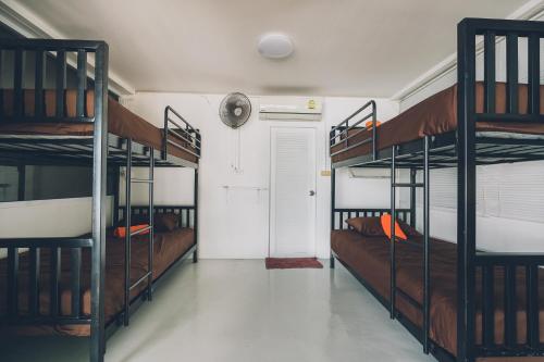 a room with three bunk beds and a door at Chill Inn Lamai Hostel & Beach Cafe in Koh Samui 