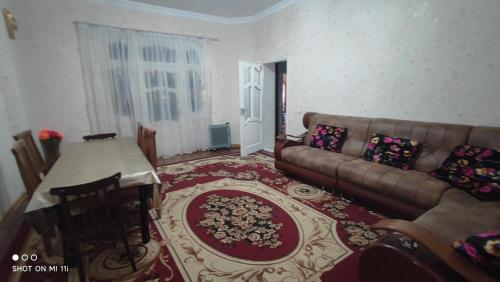 a living room with a couch and a table at Umid Hostel in Bukhara
