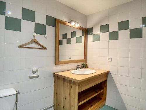 a bathroom with a sink and a mirror at Appartement spacieux & confortable, proche des pistes, balcon, sauna, hammam, WIFI inclus - FR-1-344-135 in Les Menuires