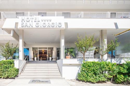 a white building with a sign that reads hotel san gregorio at Hotel San Giorgio Resort 4S in Caorle