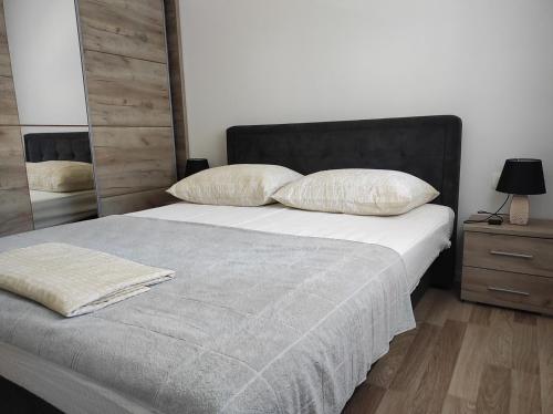 a bedroom with a bed with two pillows and a mirror at One Bedroom Apartment Gogo with Private Parking in Neum