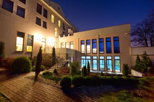 a large building at night with lights on at Hotel Kameralny in Kielce