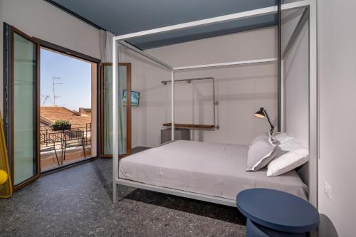 a bedroom with a bed with a glass wall at BED 10.5 - DESIGN SUITE in Castellammare del Golfo