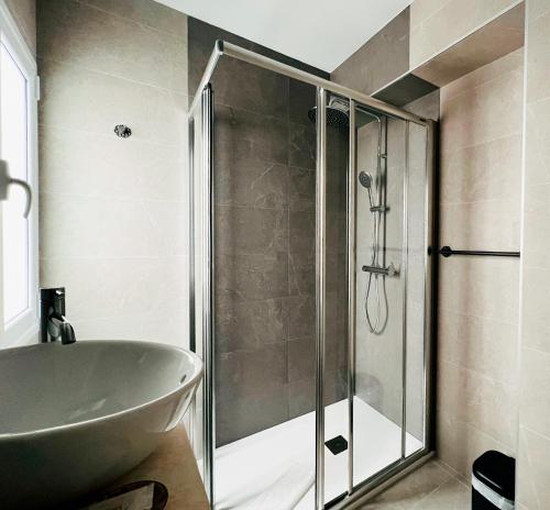 ein Badezimmer mit einer Dusche, einer Badewanne und einem Waschbecken in der Unterkunft Hostal Las Palmas in Carboneras