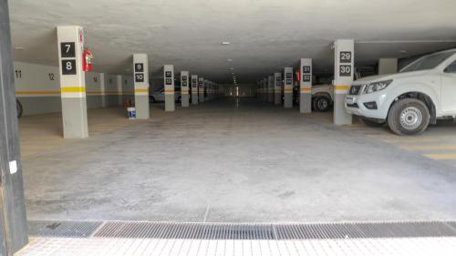 a parking lot with cars parked in a parking garage at Apart France - Con gim, piscina y estacionamiento in Río Cuarto