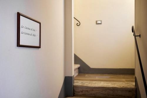 a hallway with a stairway with a picture on the wall at La Casina di Aldo in Montepulciano