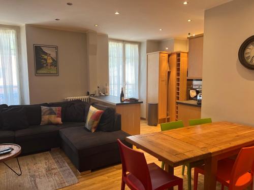 un salon avec un canapé et une table dans l'établissement onlysaintg - Apartment Bernadette Spacious 4 bedrooms Great views, 120 m2 Only 500m from the centre and ski lift GREAT YEAR ROUND, à Saint-Gervais-les-Bains