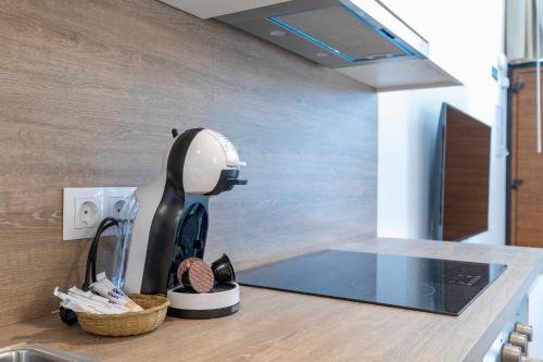 a kitchen with a hair dryer on a counter at Travel Habitat Alameda Suites. in Valencia