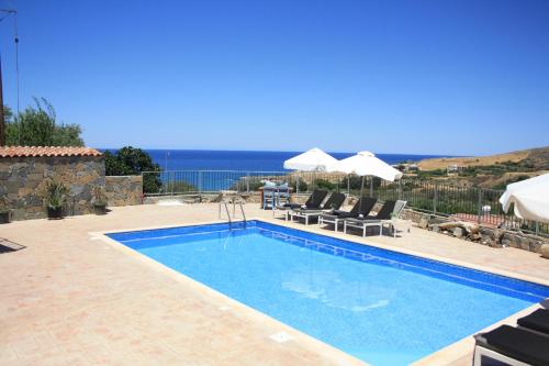 a swimming pool with a view of the ocean at Holiday Apartments,Polynikis Sea-Cret, Pachyammos in Pachyammos