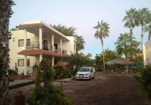 a white car parked in front of a house at Villas del Santo Niño in Loreto