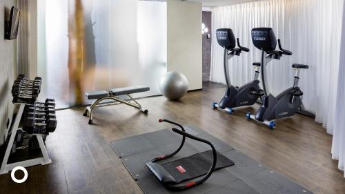 a gym with several exercise bikes and treadmills at Thingholt by Center Hotels in Reykjavík