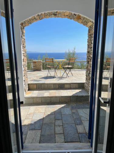 an open door to a patio with a view of the ocean at Sea view studio 2 in Batsi