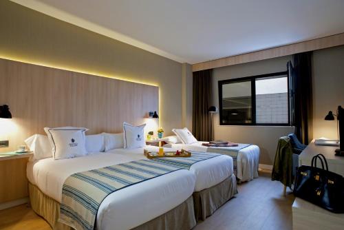 Postel nebo postele na pokoji v ubytování Aravaca Village Hotel