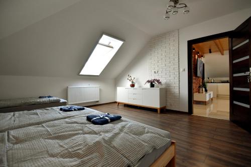 a bedroom with a bed with two blue pillows on it at Apartament u Joli in Miejsce