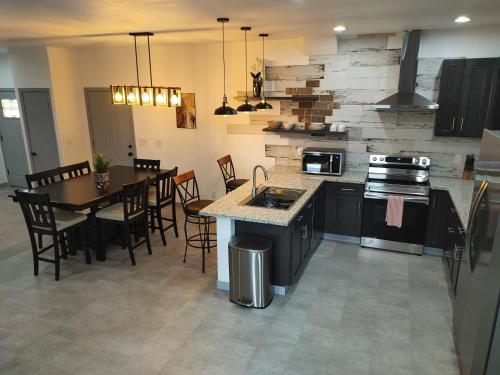 a kitchen and dining room with a table and a stove at New house with comfortable king beds in Medford