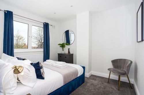 a bedroom with a bed and a chair and a window at The Carlton by Sorted Stay in Southend-on-Sea