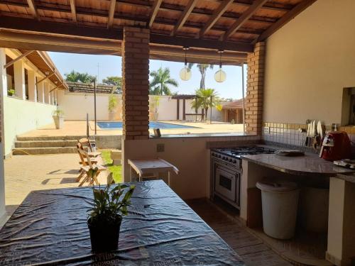 uma cozinha com uma bancada e um fogão forno superior em Chácara PALOMA em Jaguariúna