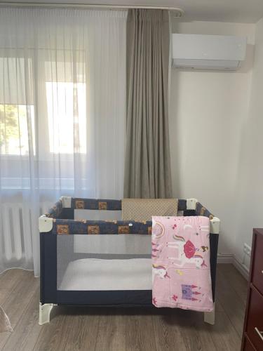 a small childs bed in a room with a window at APARTMENTS IN THE CITY CENTER BIRŽAI Vytauto g22 in Biržai