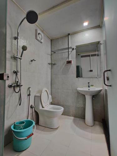 a bathroom with a shower and a toilet and a sink at Regina's Place in Mandrem